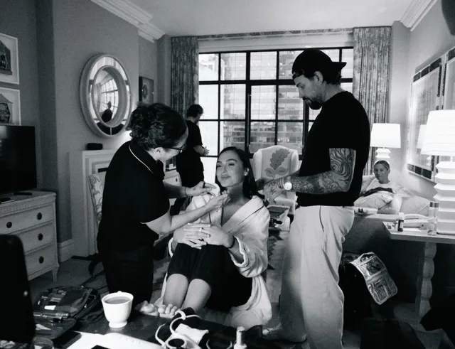Gal Gadot sitting in a makeup chair during a monochrome photograph.