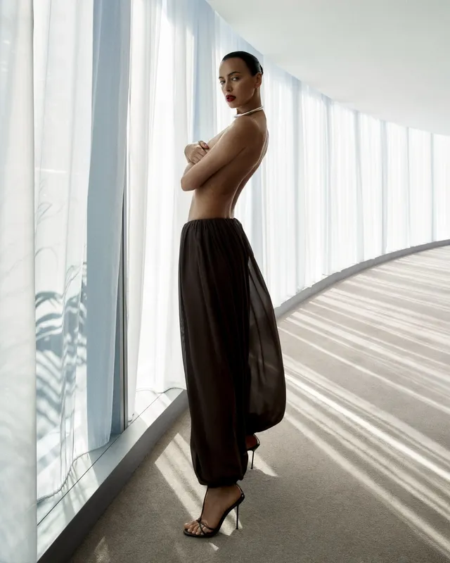Irina Shayk a window-lit portrait in a long black skirt.