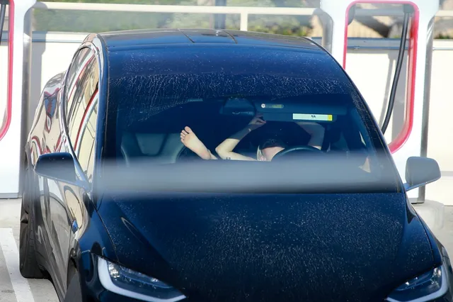 Ariel Winter resting her bare feet inside a parked car.