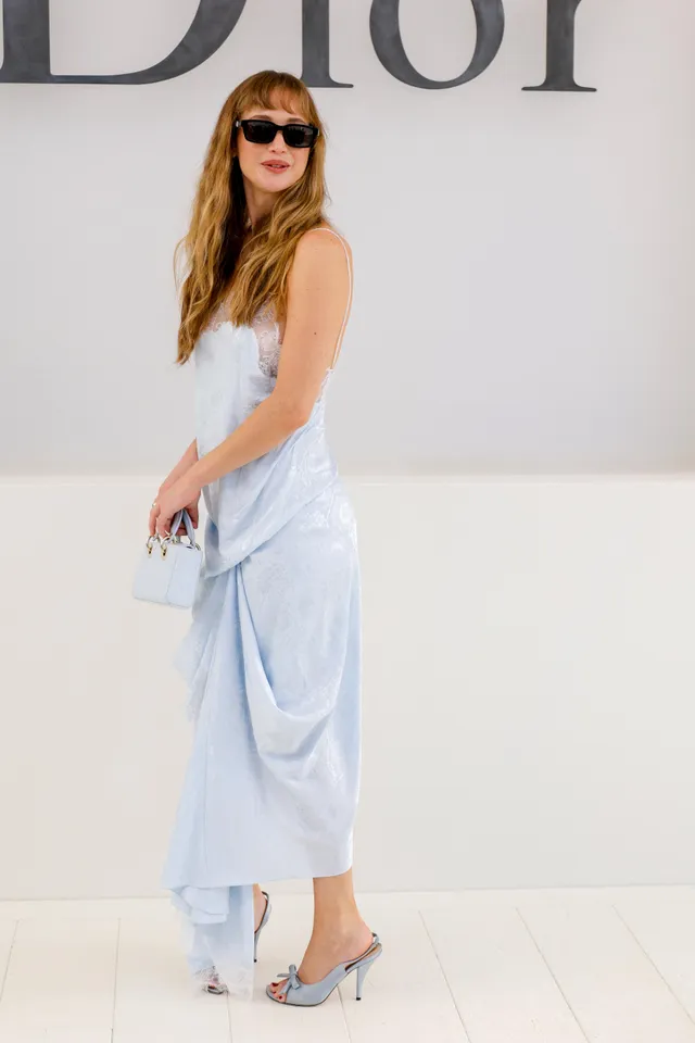 Jennifer Lawrence posing in a pale blue outfit and metallic heels.