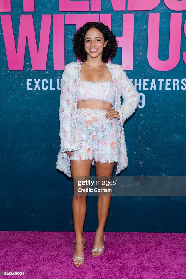 Kiana Madeira wearing a pale floral outfit and pointed heels at a premiere.