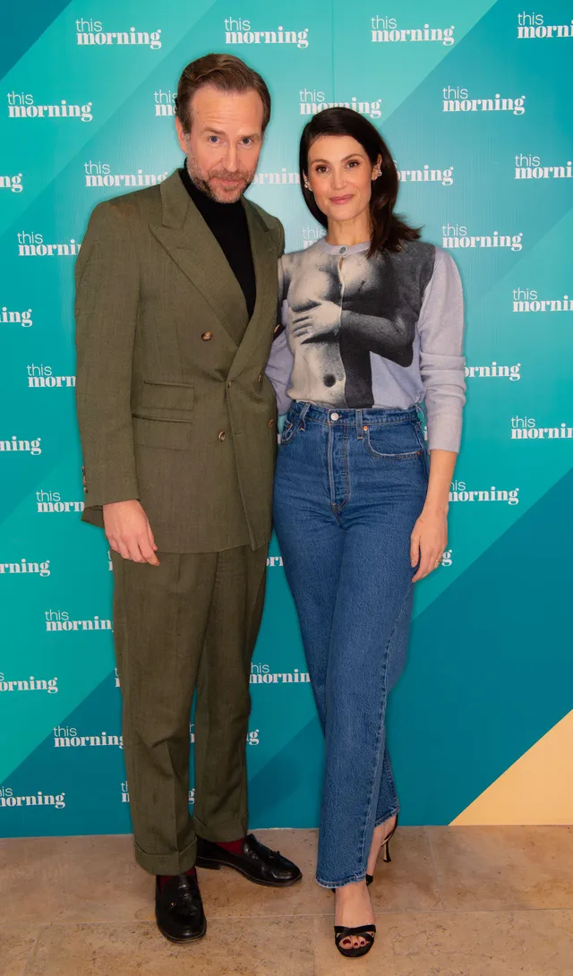 Gemma Arterton posing with a guest at a television event.