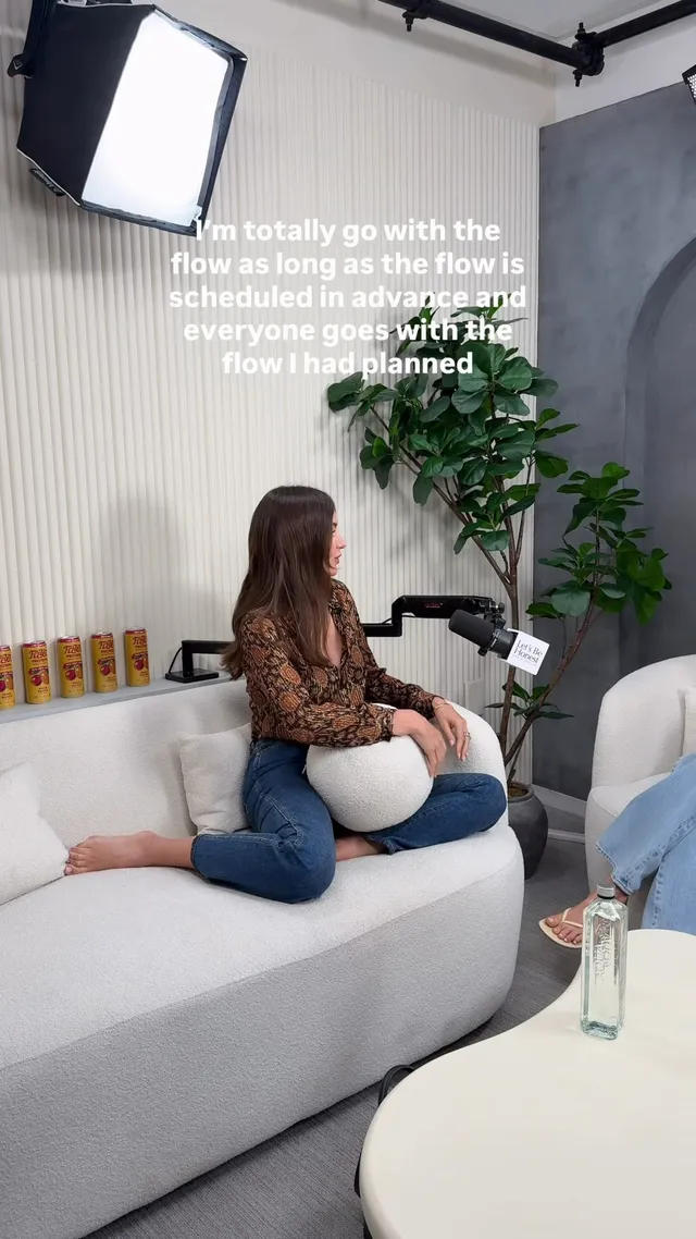 Miranda Kerr a sofa portrait in jeans and a patterned top.