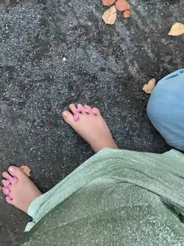 Cara Delevingne showing fresh nail polish after a pedicure.
