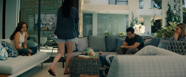 Chase Sui Wonders standing in heels in an interior scene.