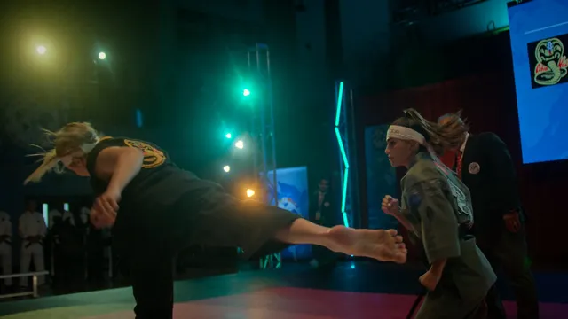 Peyton List extending a bare leg during a martial-arts scene.