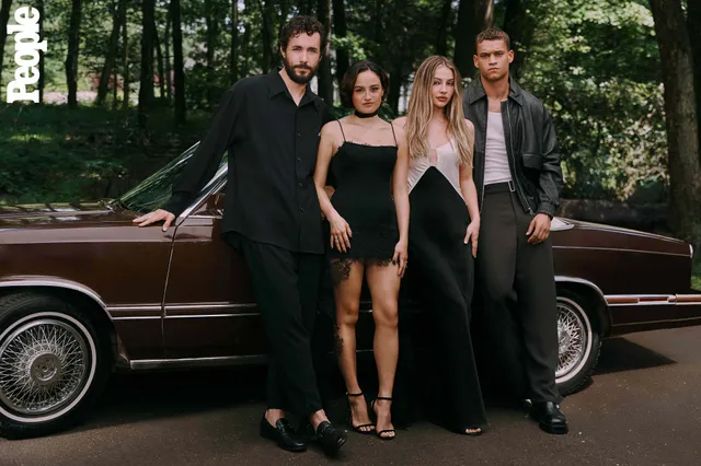 Chase Sui Wonders posing with cast members beside a car in black heels.