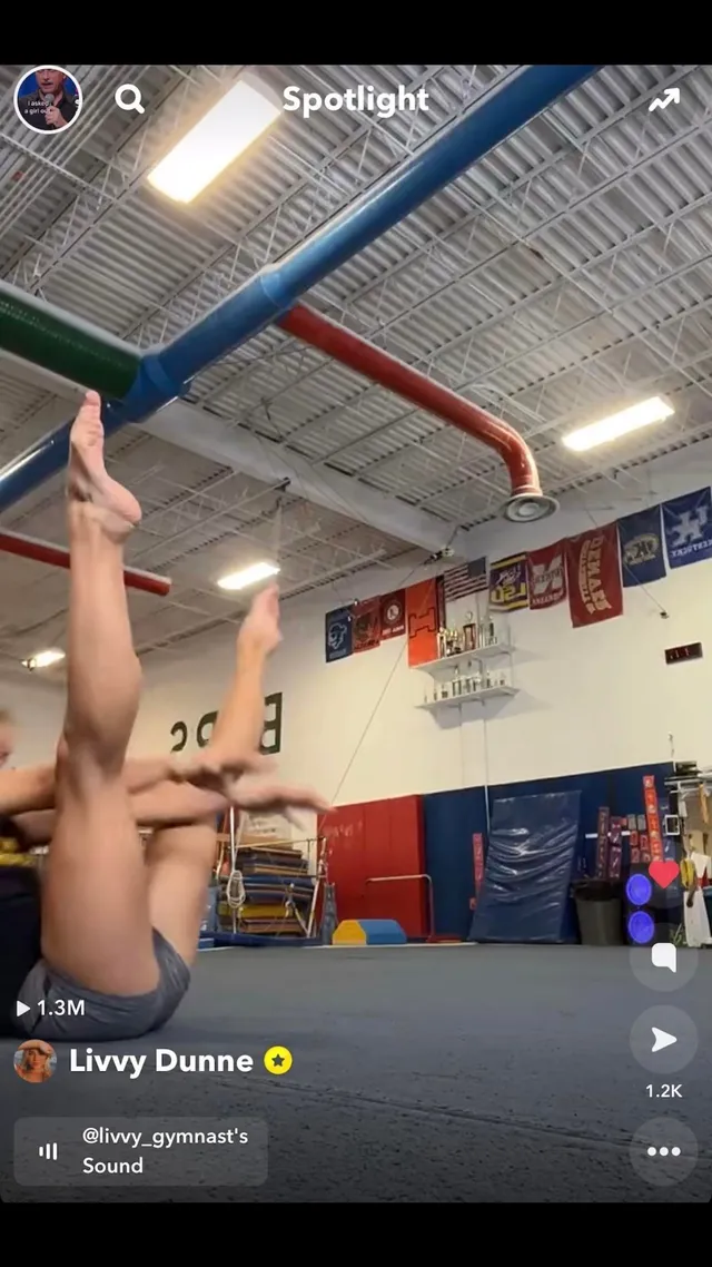 Olivia Dunne performing a handstand in a training gym.