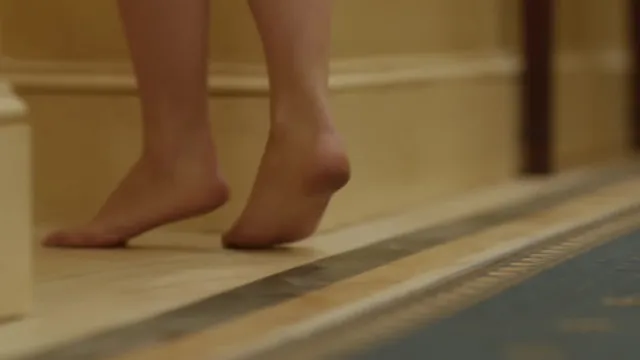 Olivia Wilde raising a bare heel in a film scene.