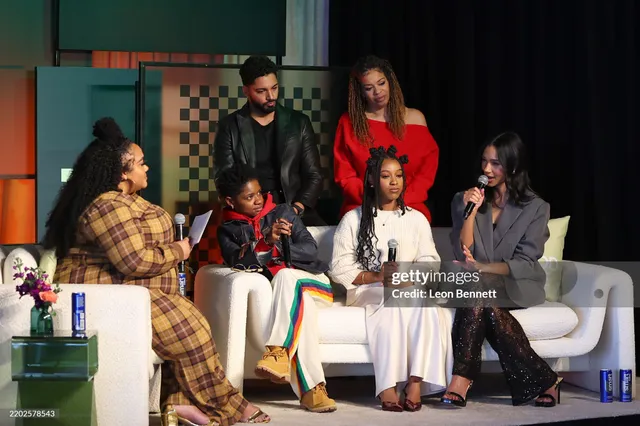 Greta Onieogou sitting with a group during an interview in black open-toe heels.