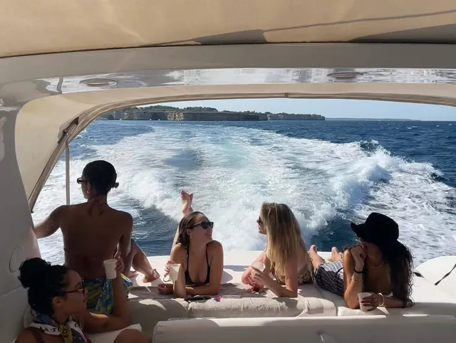 Alycia Debnam-Carey sitting with companions on a boat.