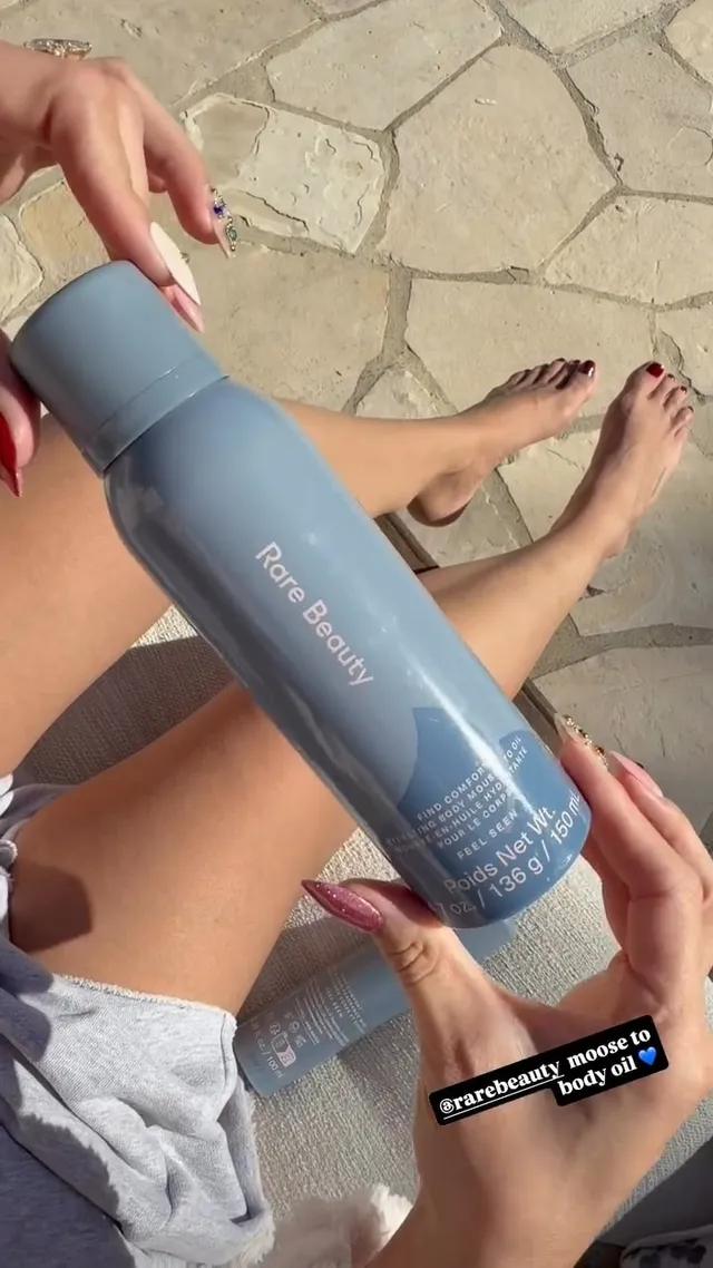 Selena Gomez sitting with her feet visible during a salon treatment.