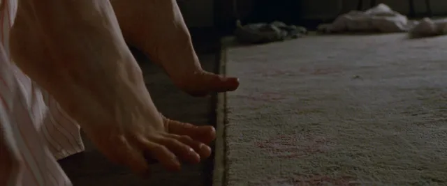 Natalie Portman resting bare feet in a screen scene.