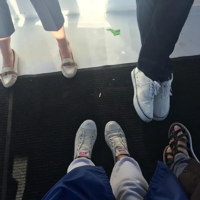 Maia Mitchell wearing flat sandals in a group photograph.
