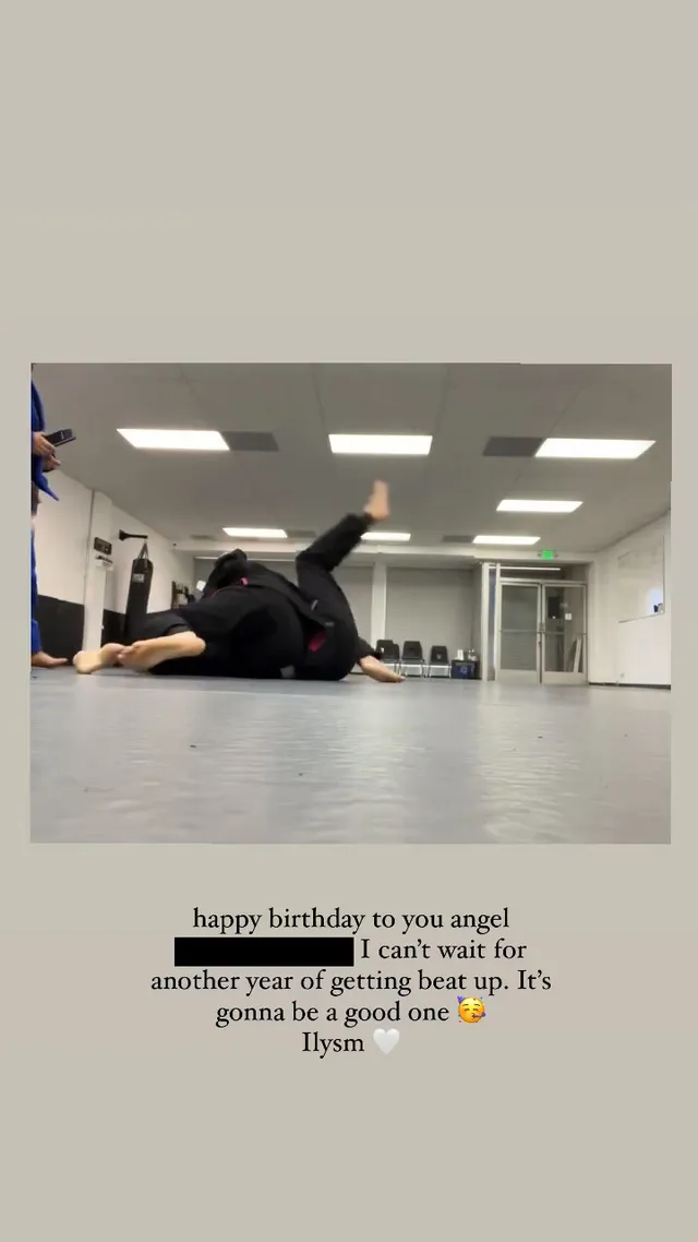 Chloë Grace Moretz stretching on a dance studio floor.