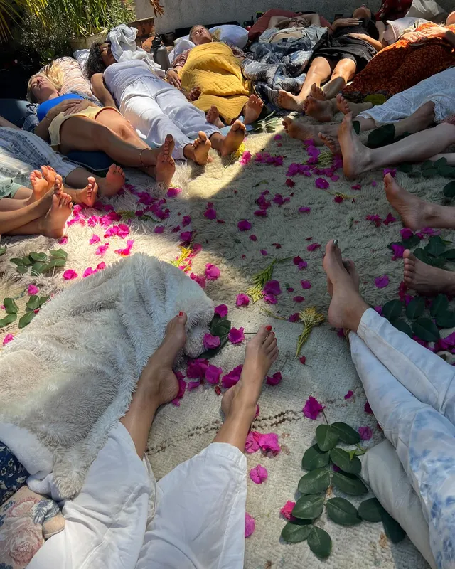 Teresa Palmer lying with companions during an outdoor gathering.