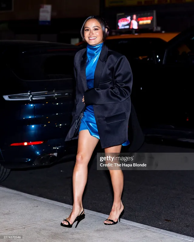 Chase Sui Wonders walking in a blue dress and black heels.