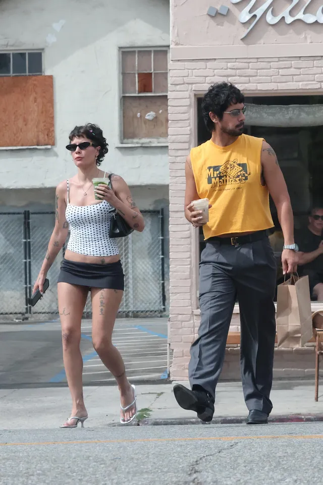 Halsey a casual outfit and flip-flops on a city street.