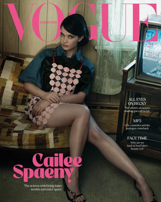 Cailee Spaeny posing in a patterned dress and heels for a magazine cover.