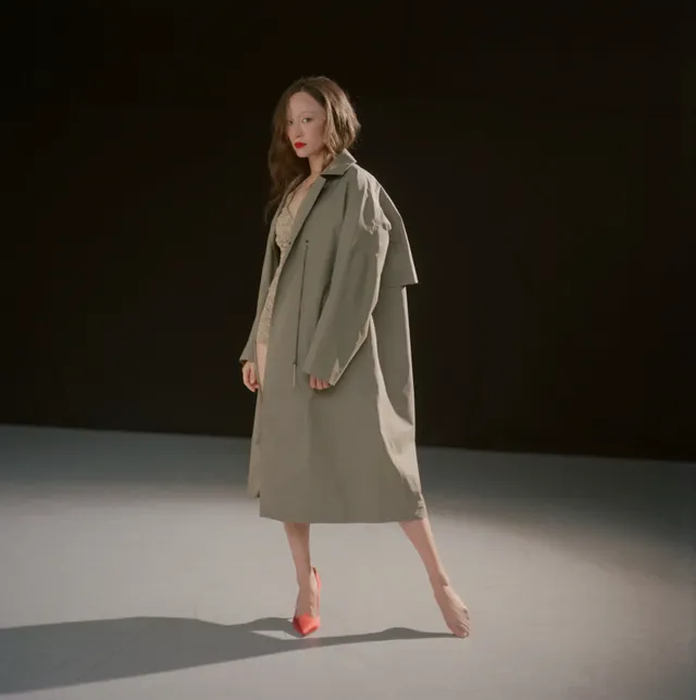 Havana Rose Liu posing in a coat and heels in a studio.