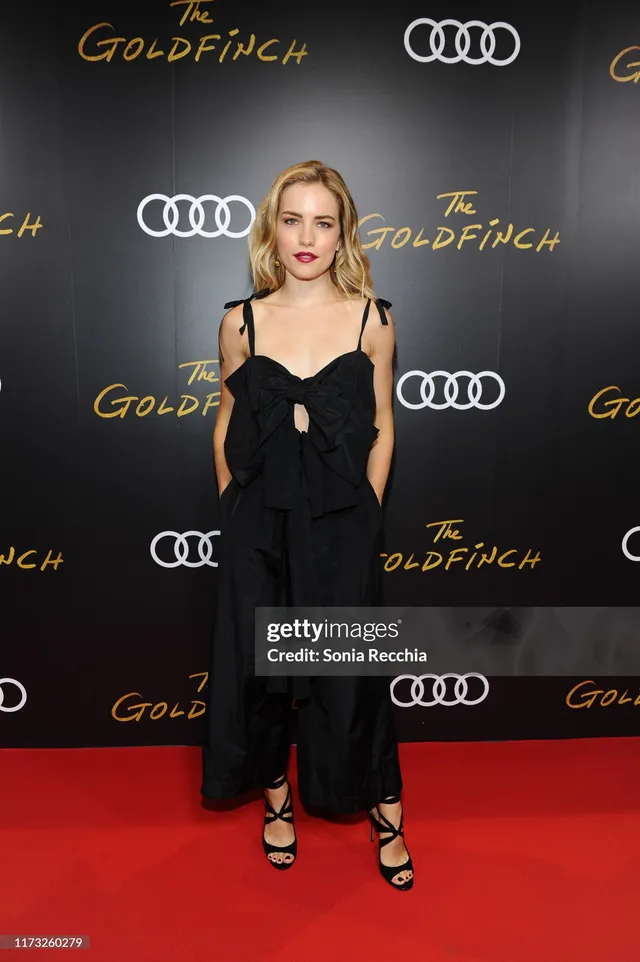 Willa Fitzgerald wearing a black outfit and heels at a premiere.