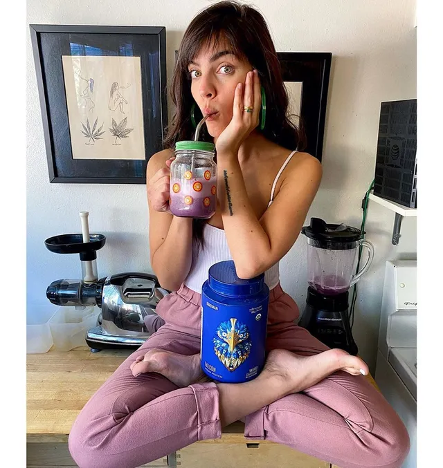 María Gabriela de Faría sitting barefoot cross-legged on a kitchen counter.