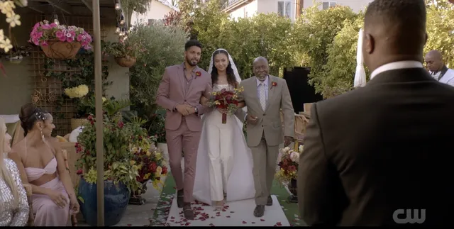 Samantha Logan standing with fellow performers in a wedding scene.