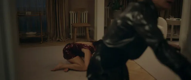 Olivia Cooke kneeling on the floor with another performer nearby.