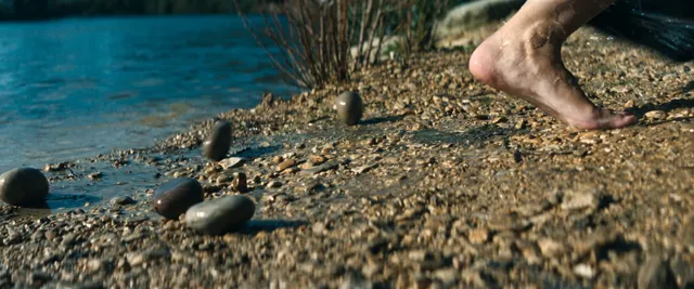 Tessa Thompson walking beside the water in a screen scene.
