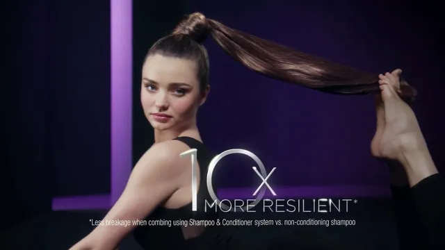 Miranda Kerr a hair-care portrait with bare feet raised.