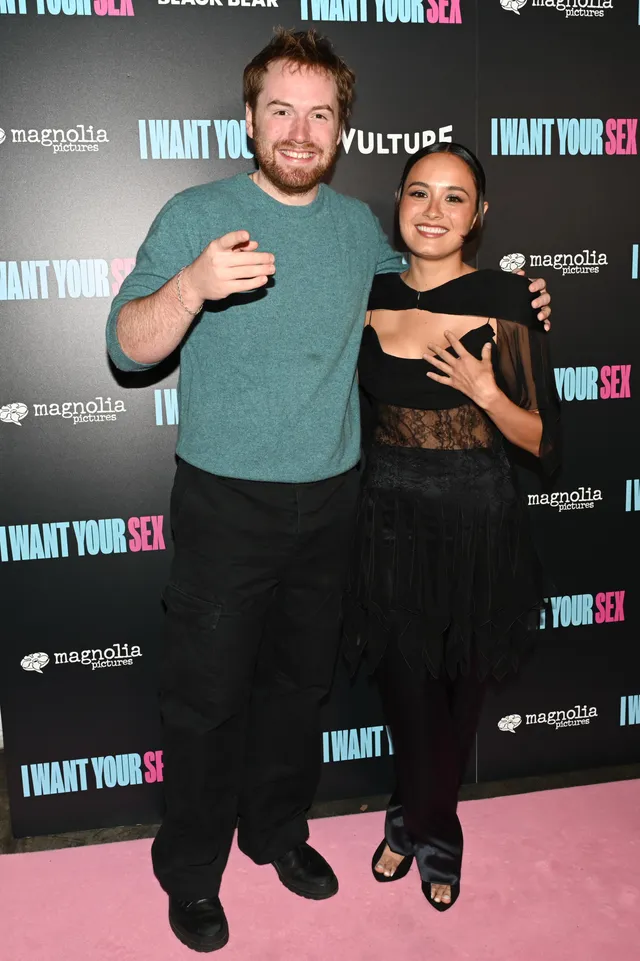 Chase Sui Wonders posing with a guest in black trousers and heels.