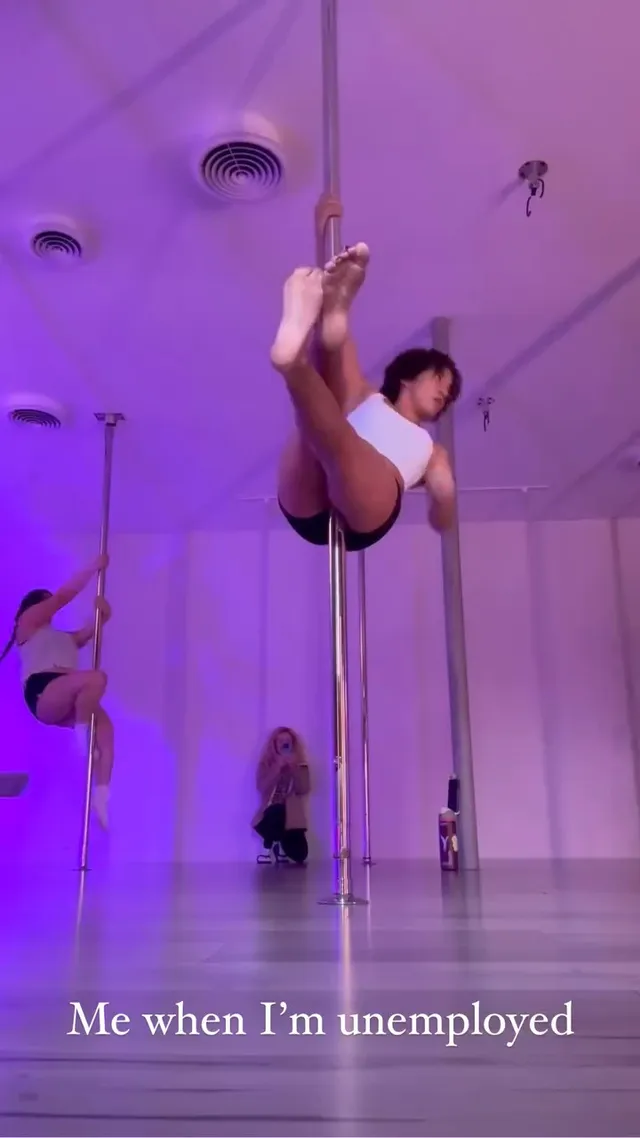 Isabela Merced practising a barefoot pole-dance move in a studio.