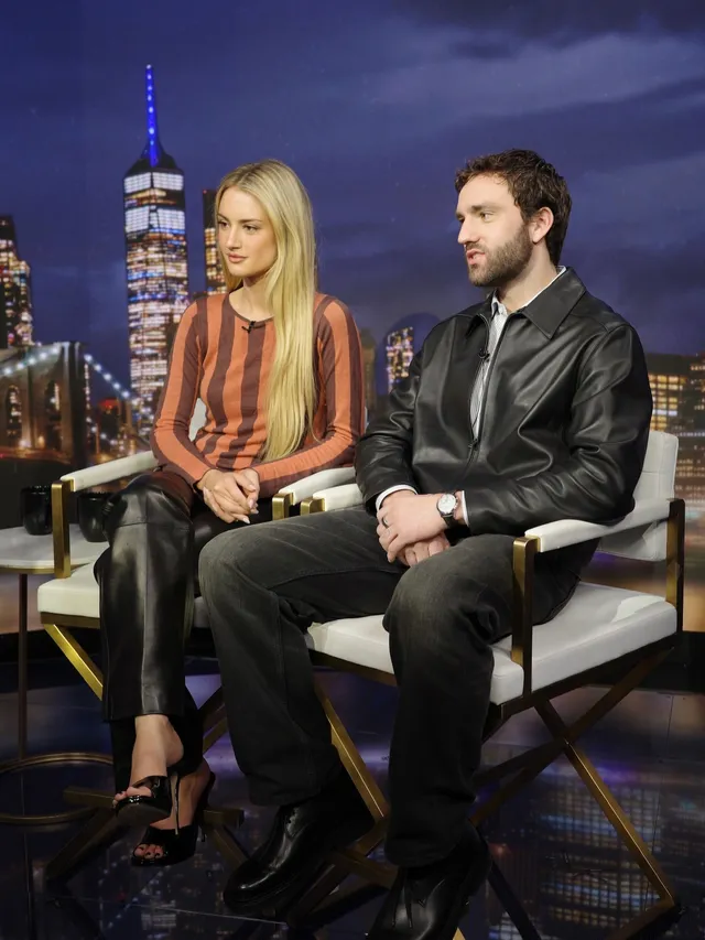 Grace Van Patten sitting for an interview in a striped top and black trousers.