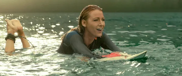 Blake Lively floating in water with bare soles raised in a screen scene.