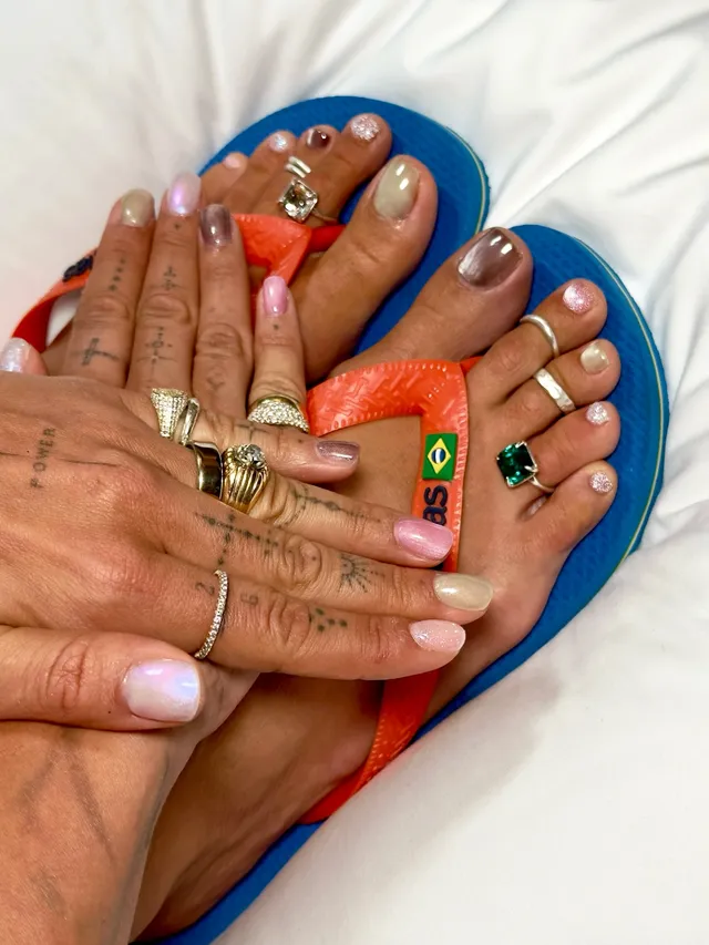 Rita Ora showing rings and colourful flip-flops.