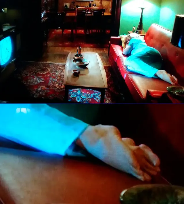 Amy Adams reclining on a sofa during a screen scene.