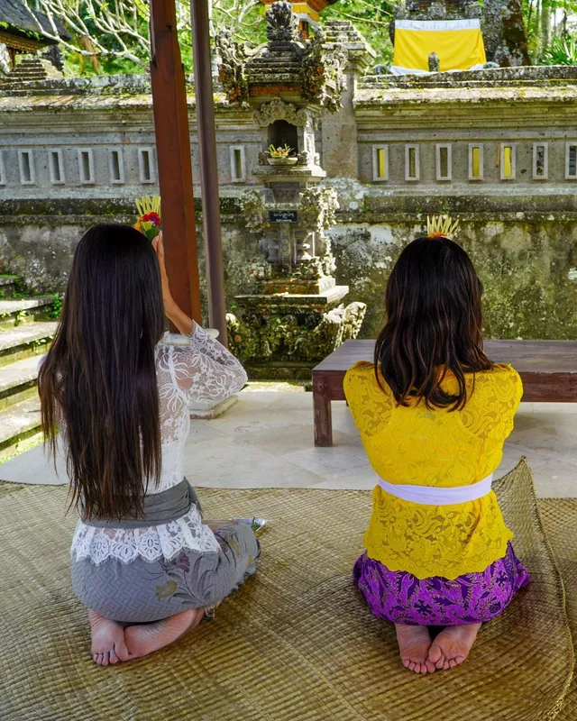 Lucy Hale kneeling beside a companion during an outdoor visit.