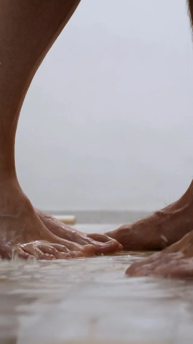 Grace Van Patten shown in a close-up of bare feet on a carpet.