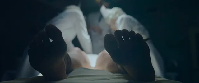 Florence Pugh a screen scene with bare soles facing the camera.