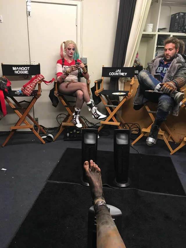 Cara Delevingne resting her feet during a cast interview.