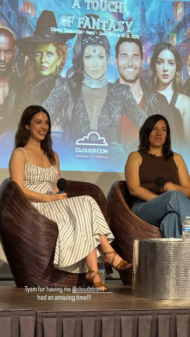 Adelaide Kane sitting beside a companion during a panel discussion.
