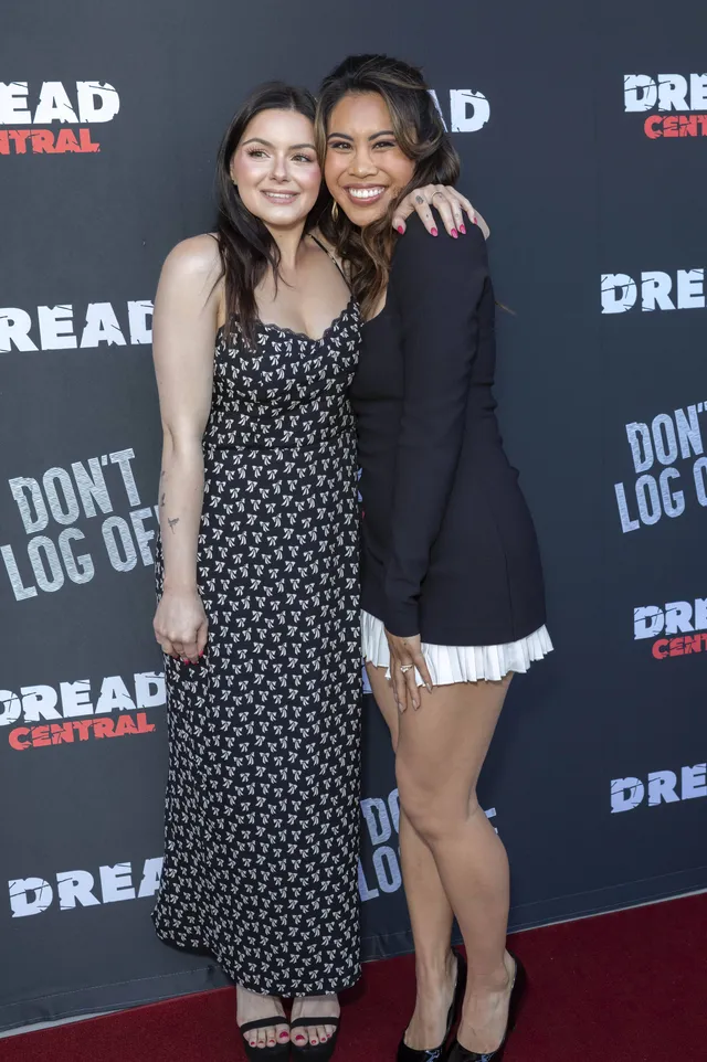 Ariel Winter posing with a companion against a film event backdrop.
