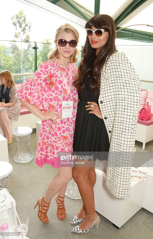 Natalie Dormer posing with a guest in a pink patterned dress.