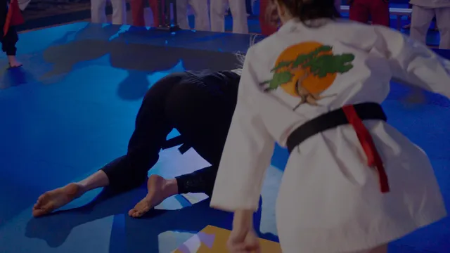 Peyton List practicing martial arts barefoot on a mat.