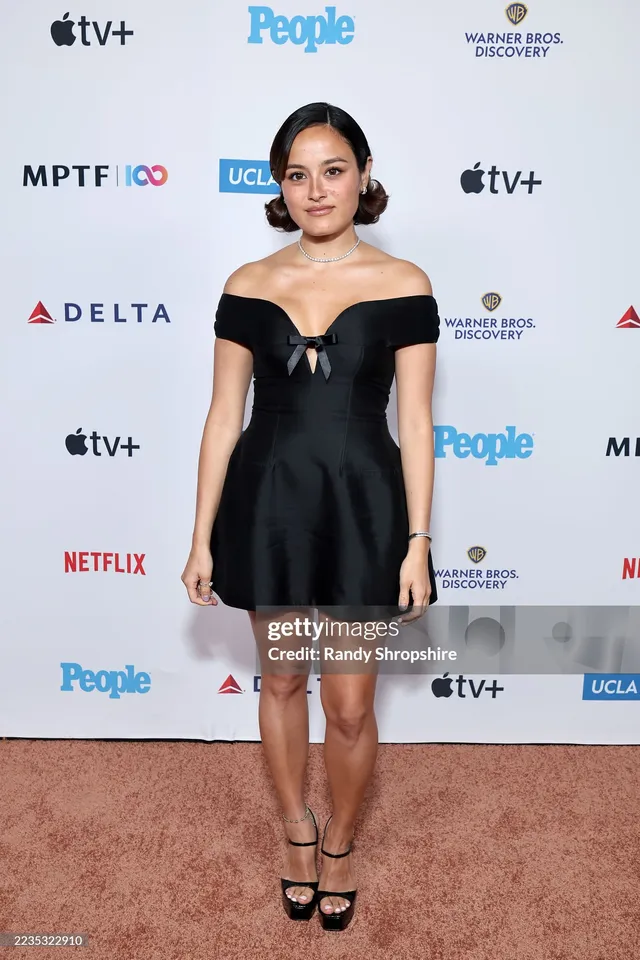 Chase Sui Wonders wearing a black dress and heels at an event.