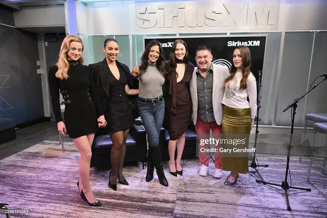 Victoria Pedretti posing with fellow guests during a radio visit.