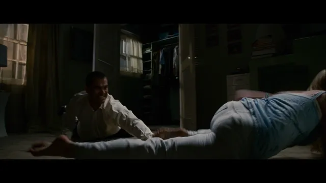 Brittany Snow reclining on the floor during a screen scene.