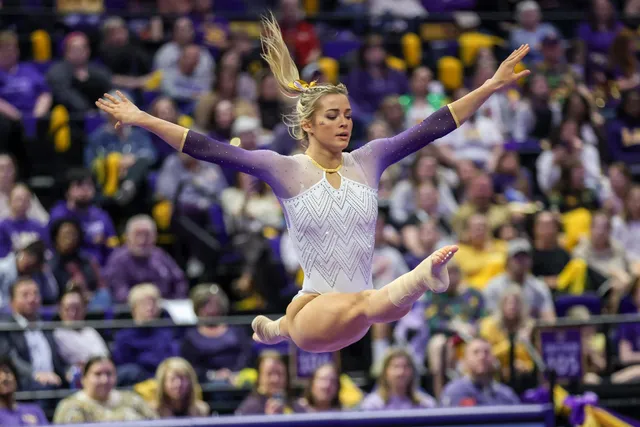Olivia Dunne: performing a barefoot split leap at a gymnastics meet.