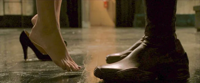 Kate Bosworth stepping out of black pumps in a screen scene.