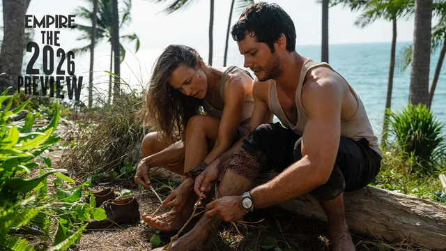 Rachel McAdams sitting on a log beside another person on a beach.